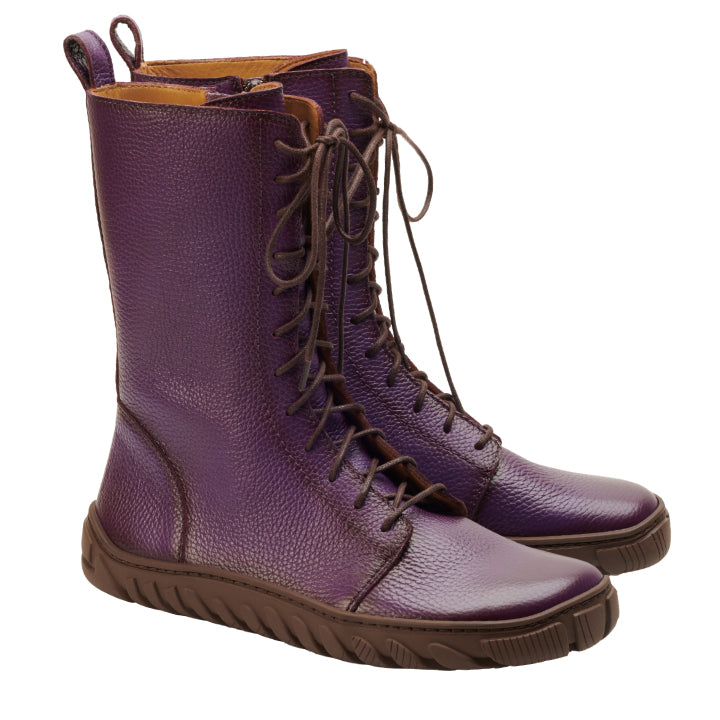 Wir präsentieren den DOQS Purple von ZAQQ: ein Paar hohe Lederstiefel in einem auffälligen Lilaton, gefertigt aus hochwertigem Nappaleder. Diese Stiefel haben braune Sohlen und Schnürsenkel, sind mit einer strukturierten Oberfläche gestaltet und mit einer ULTRAGRIP-Sohle für mehr Stil und Einzigartigkeit ausgestattet. Vor einem weißen Hintergrund verkörpern sie sowohl Eleganz als auch Funktionalität.