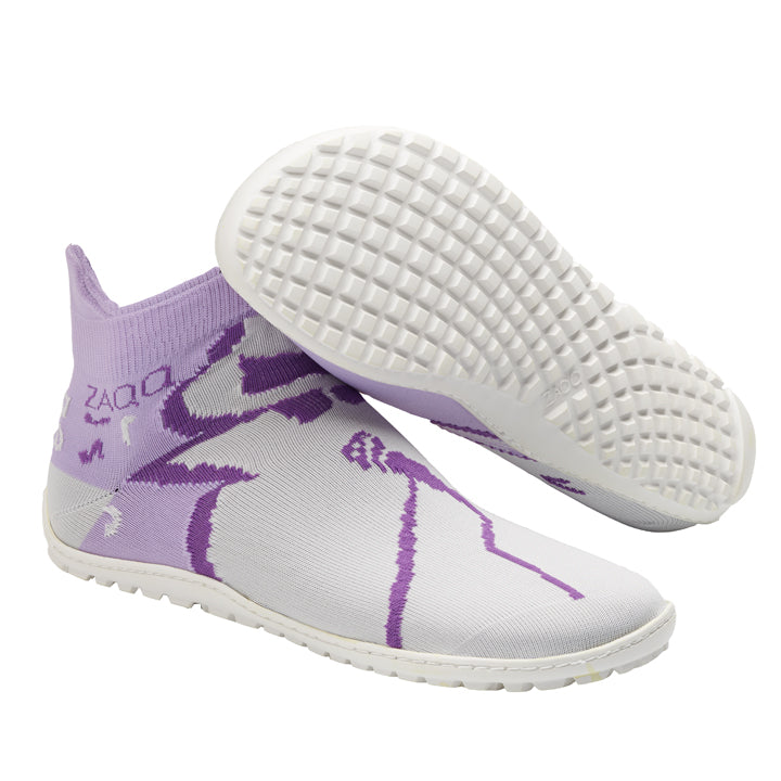 Der SOQQ Jazz Purple Slip-On-Sockenschuh von ZAQQ präsentiert sich in einem High-Knöchel-Design in Lila und Weiß, komplett mit einer flexiblen, strukturierten Barfußsohle. Die Schuhe weisen ein abstraktes Muster auf, wobei ein Schuh aufrecht steht und der andere die Sohle betont.